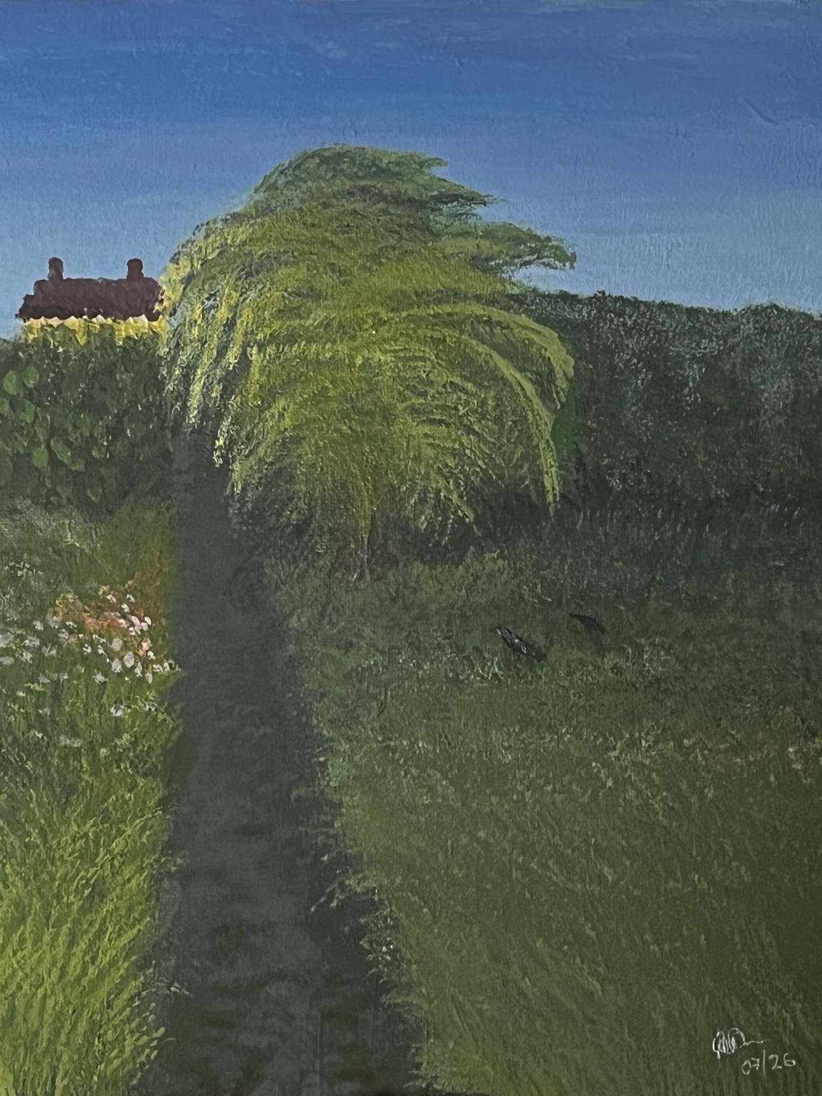 A bright garden path leading beneath a large green tree towards a red-roofed house